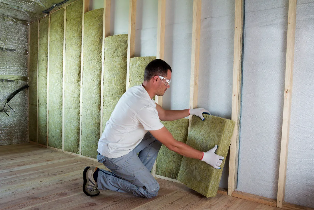 Insulation being fitted between timber studs