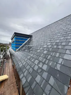 Natural slate roof finished beside the dormer
