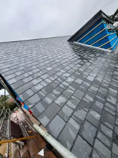 The finished slate roof and dormer